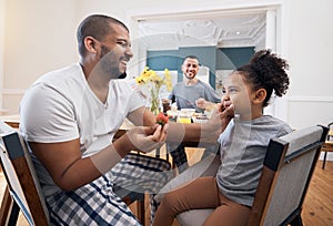 Gay couple, breakfast or child with father wipe, cleaning or remove food, morning meal or cereal from mouth of girl