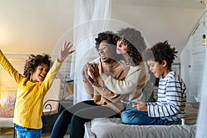 Gay couple children love happiness concept. Happy multiethnic family spending time together at home