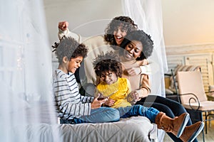 Gay couple children love happiness concept. Happy multiethnic family spending time together at home