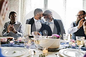 Gay Couple Hands Cutting Wedding Cake