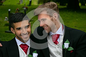 Gay weddings, grooms, couples pose for pictures after their wedding ceremony in churchyard