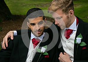 Gay weddings, grooms, couples pose for pictures after their wedding ceremony in churchyard