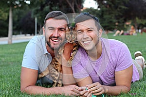 Gay couple in the park with their pet