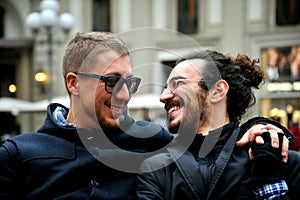 Gay couple smiling on the streets of Florence , Italy