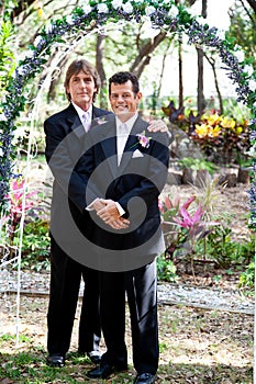 Gay Couple Under Wedding Arch