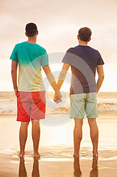 Gay couple watching sunset photo