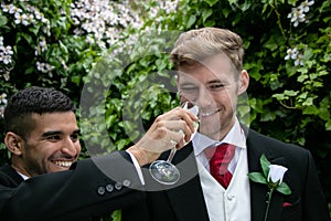 Gay couple at wedding reception toast being married