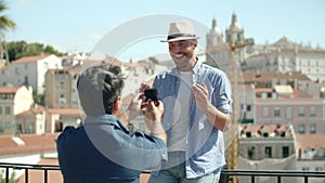 Gay kneeling and proposing to his lover outdoors on summer day