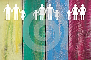 Gay lesbian and straight families on wooden coloured background