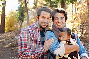 Gay Male Couple With Baby Walking Through Fall Woodland