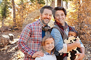 Gay Male Couple With Children Walking Through Fall Woodland