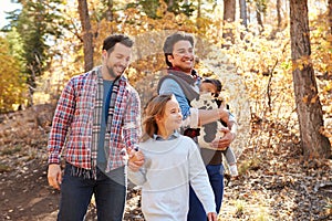 Gay Male Couple With Children Walking Through Fall Woodland