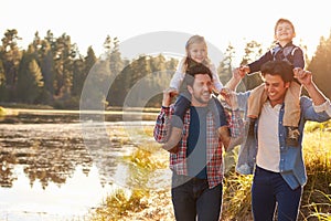 Gay Male Couple With Children Walking By Lake