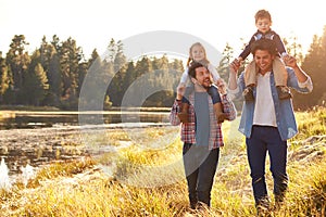 Gay Male Couple With Children Walking By Lake