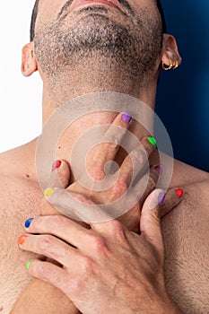 Gay man with colorful nails, rainbow colors, freedom, no prejudice, beautiful nails, blue and green clothes on a blue background. photo