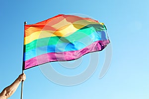 Gay man holding rainbow LGBT flag