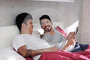 Gay Man Playing Video With Partner In Bed