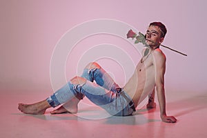 gay man posing sexily in a glamorous Valentine& x27;s Day-themed photoshoot