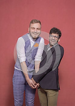 Gay men acting silly, holding hands together