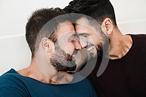 Gay men couple having tender moment together at home - Homosexual, multiracial love and relationship concept - Main focus on left