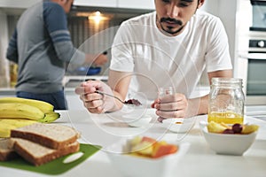 Gay People Having Breakfast Cooking In Home Kitchen