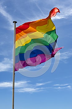 The Gay Pride flag fluttering in the wind