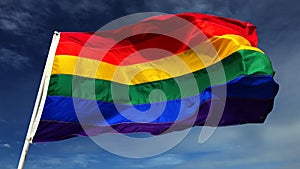 Gay Pride Rainbow Flag on Flagpole Blue Sky