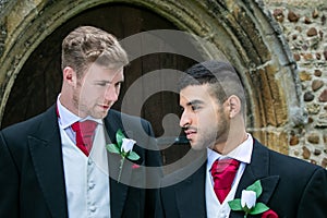 Gay wedding, grooms leave village church after being married with big smiles and holding hands
