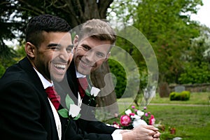 Gay weddings, grooms, couples pose for pictures after their wedding ceremony in churchyard