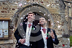 Gay wedding, grooms leave village church after being married to smiles and confetti