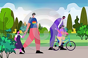 gays family walking with little children in park fatherhood transgender love LGBT community concept