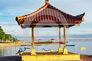 gazebo on the beach with a sunrise atmosphere