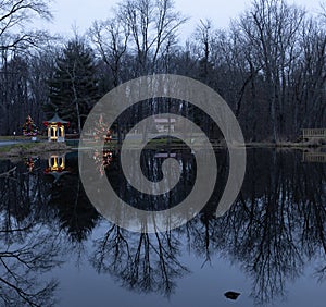 Gazebo and Christmas tree reflected on a lake