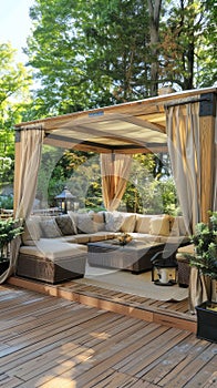 a gazebo with an elegant and sturdy wooden structure, adorned with tan fabric canopies, as seen from the front of a cozy