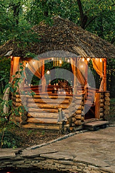 Gazebo with lights in late evening. Romantic scene in dusk. Vertical photo orientation