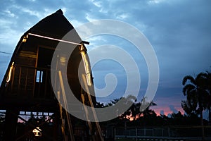 Gazebo view on evening blue sky with purple sky behind the trees