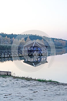 Gazebo on the water. photo of a spacious gazebo in the country