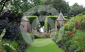 Gazebos at the end of the Red Border in the Arts and Crafts inspired garden at Hidcote Manor in the Cotswolds, Gloucestershire UK