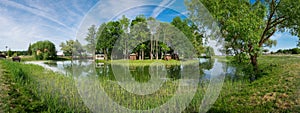 Gazebos on shore of pond in park of Kossovo village, Brest region, Belarus.