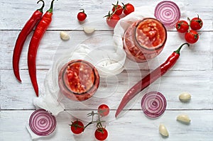 Gazpacho soup with fresh ingredients - three hot red chili peppers, onion rings, garlic and small cherry tomatoes