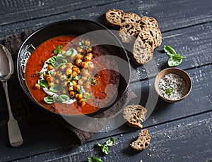 Gazpacho soup with spicy fried chickpeas on a dark background. Vegetarian healthy food diet weight loss