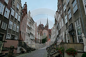 Gdansk - A deserted street in Old Town of Gdansk, Poland. The both sides of a paved alley have tall medieval buildings