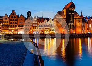 Gdansk night city riverside view. View on famous crane and facades of old medieval houses