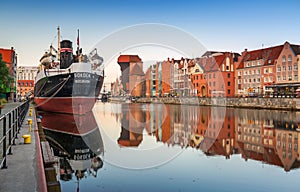 Gdansk, Poland - July 25, 2019: Old town of Gdansk wth Soldek ship at sunrise, Poland. Gdansk is the historical capital of Polish