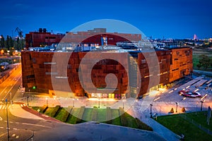 Gdansk, Poland - October 11, 2020: Rusty steel building of European Solidarity Centre in Gdansk at night, Poland. The ECS museum