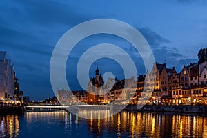 GdaÅ„sk Old Town and the glowing bridge over the MotÅ‚awa River in the evening