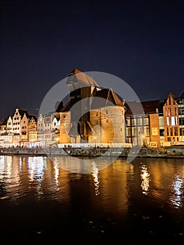 GdaÅ„sk Old Town - the Historical Port Crane Gate and Houses on the MotÅ‚awa River in the Evening Time