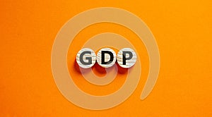 GDP, gross domestic product symbol. Concept word `GDP, gross domestic product` on circles on a beautiful orange background.