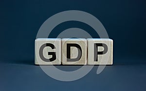 GDP, gross domestic product symbol. Concept word `GDP, gross domestic product` on cubes on a beautiful grey background. Business