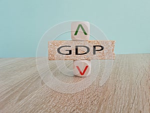 GDP gross domestic product symbol. A cube with up icon. Brick block with word GDP. Beautiful blue background.